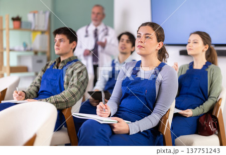 Construction students listening to a lecture against the background of a teacher's doctor 137751243