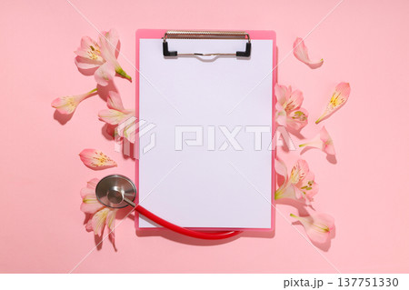 Clipboard and stethoscope with flowers nearby for Nurses Day 137751330