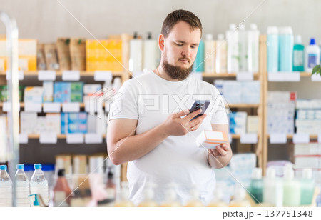 Young man scanning qr code of pills 137751348
