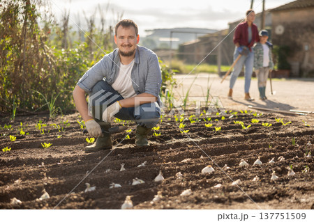 Farmer planting seeds in the garden 137751509