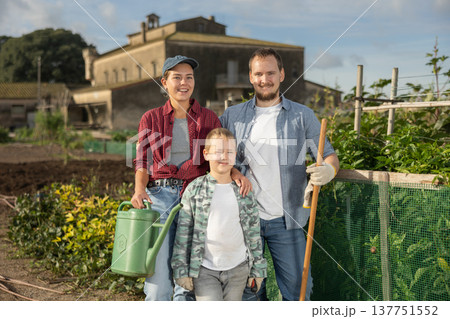 Man woman and boy near field harvest Man woman and boy near field harvest 137751552