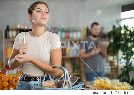 Young woman choosing food at grocery store 137751654