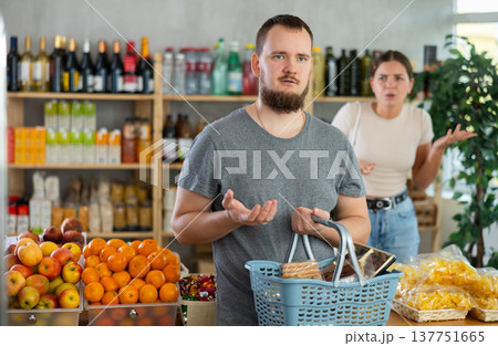 Young woman quarrels with man in grocery store Young woman quarrels with man in grocery store 137751665