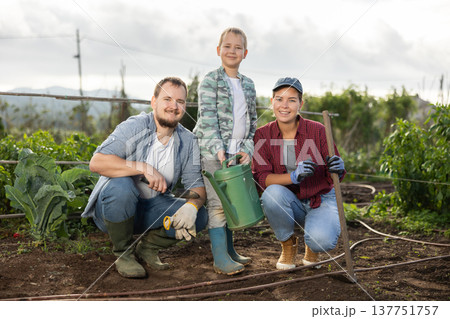 Family of farmers standing in the garden Family of farmers standing in the garden 137751757