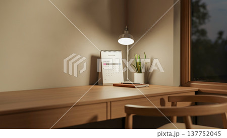 Book and calendar under lamp light on wooden table and chair aside window in dim lit room's corner. Book and calendar under lamp light on wooden table and chair aside window in dim lit room's corner. 137752045