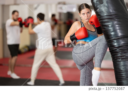 Woman kicking a pear tree Woman kicking a pear tree 137752087