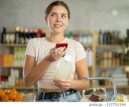 Young woman scanning qr code of soda Young woman scanning qr code of soda 137752144