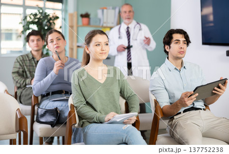 Students listen to lecture in classroom, with medical professor in background Students listen to lecture in classroom, with medical professor in background 137752238