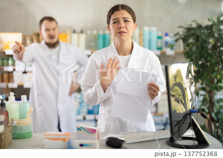 Female pharmacist at the time of dismissal in a pharmacy 137752368