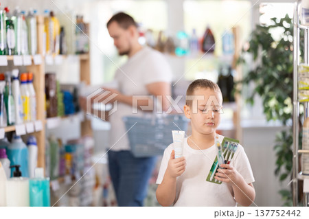 Schoolboy choosing toothbrush in store 137752442