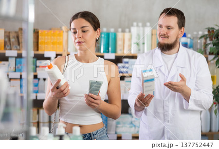 Woman choosing cream with help from pharmacist Woman choosing cream with help from pharmacist 137752447