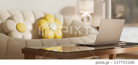 Laptop on glass top table aside white pumpkin sofa and yellow flower cushion in a modern living room 137753160