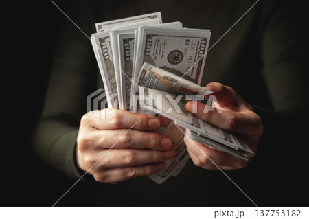 Hands counting US dollar banknote, symbolizing finance, payment, banking 137753182
