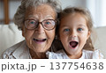 Joyful grandmother granddaughter portrait, happy family bonding, laughing expressions, close up face, generation love, elderly woman, little girl 137754638