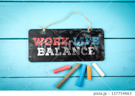 Work-Life Balance Chalkboard Sign On Blue Wooden Background Work-Life Balance Chalkboard Sign On Blue Wooden Background 137754663