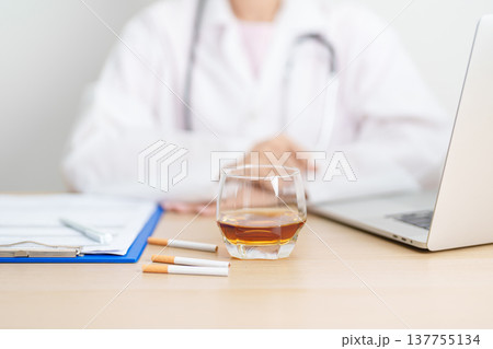 doctor hand making stop sign to refuse whiskey and breaking cigarette, quit smoking and drinking for healthy liver and lung, World No Tobacco and No Alcohol Day and stop alcohol addiction concept doctor hand making stop sign to refuse whiskey and breaking cigarette, quit smoking and drinking for healthy liver and lung, World No Tobacco and No Alcohol Day and stop alcohol addiction concept 137755134