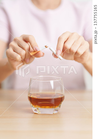 woman hand break and stop gesture to refuse cigarette and glass of Whisky, for say no to alcohol drink and for World No Tobacco Day, quitting smoking to prevent Lung Cancer and stop nicotine addiction 137755165