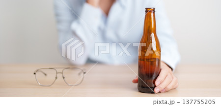 Stressed man drinking beer alone with problem. Exhausted drunk man looking stressed and sleepy. Alcohol addiction, Alcoholism, emotional distress and mental health concept Stressed man drinking beer alone with problem. Exhausted drunk man looking stressed and sleepy. Alcohol addiction, Alcoholism, emotional distress and mental health concept 137755205