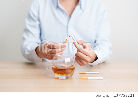 Man hand break and stop gesture to refuse cigarette and glass of Whisky, for say no to alcohol drink and for World No Tobacco Day, quitting smoking to prevent Lung Cancer and stop nicotine addiction 137755221