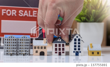Hand Placing House Model near For Sale Sign Real Estate Concept Hand Placing House Model near For Sale Sign Real Estate Concept 137755891