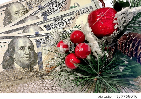 Christmas Cash and Holiday Decorations. $100 dollar bills with festive ornaments. Perfect for holiday budget, bonus, and shopping concepts. 137756046
