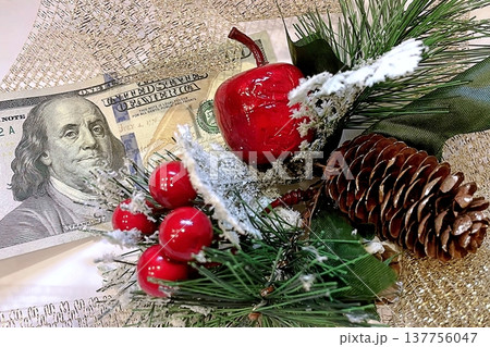 Christmas Cash and Holiday Decorations. $100 dollar bills with festive ornaments. Perfect for holiday budget, bonus, and shopping concepts. 137756047