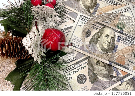 Christmas Cash and Holiday Decorations. $100 dollar bills with festive ornaments. Perfect for holiday budget, bonus, and shopping concepts. 137756051