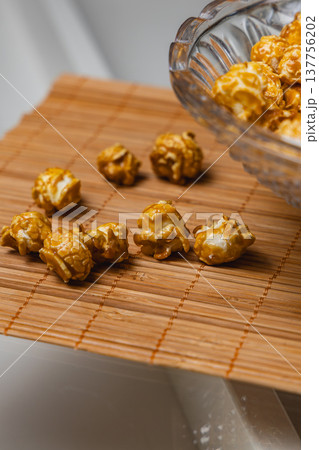 Popcorn on bamboo mat with bowl tilted during snack time 137756202