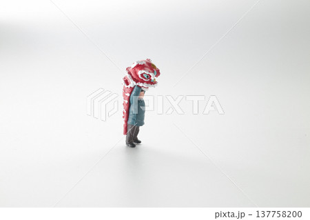 Miniature Performer Lifts Vibrant Red lion Head Upward 137758200