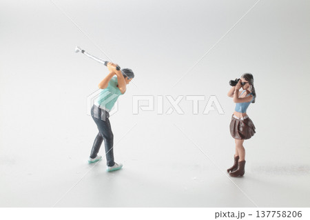 Miniature Golfer Swings Club While Photographer Captures Action 137758206