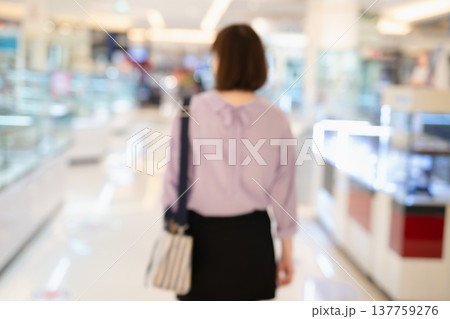 abstract blur backside of short hair asian woman shopping at mall during sale and discount with wear protective mask abstract blur backside of short hair asian woman shopping at mall during sale and discount with wear protective mask 137759276