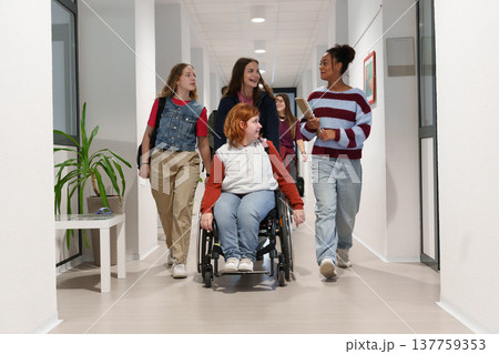 Teen students in school hallway, girl in wheelchair. 137759353