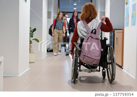 Teen students in school hallway, girl in wheelchair. 137759354