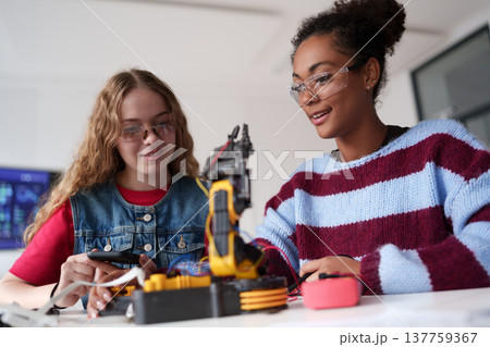 High school students working on robotics project. Girls in STEM. 137759367