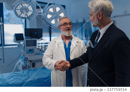 Pharmaceutical sales representative shaking hand with doctor. 137759554