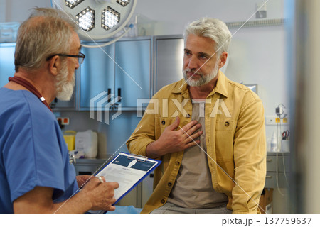 Patient explaing his health issues to older doctor. 137759637