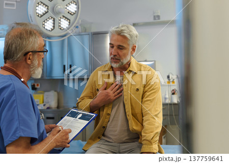 Patient explaing his health issues to older doctor. 137759641