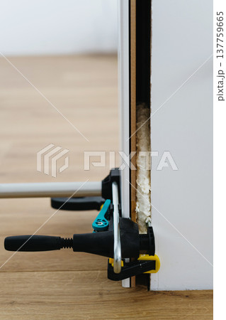 Close up on clamps on door frame during home renovation. Close up on clamps on door frame during home renovation. 137759665