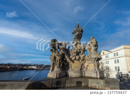 24 Feb 2026,Prague, Czech Republic. Baroque statues on the historic Charles Bridge with tourists walking across Vltava River against a beautiful cloudy sky 137759837