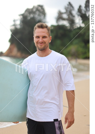 Casual Beach Surfer Image. Luminous Beach Scene Featuring Calm Surfer With Surfboard And Casual Attire Casual Beach Surfer Image. Luminous Beach Scene Featuring Calm Surfer With Surfboard And Casual Attire 137760332