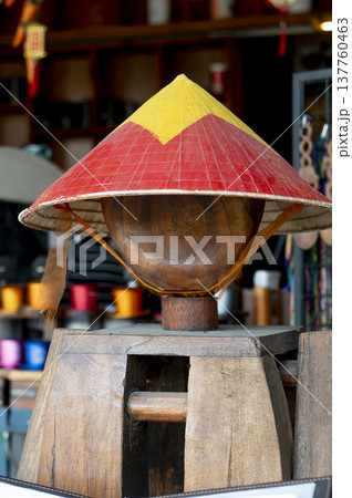 Vietnamese conical hat on wooden stand in traditional souvenir shop 137760463