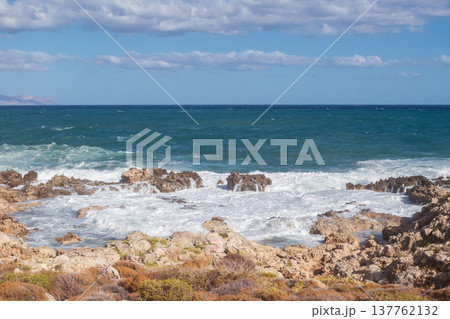 Mediterranean seascape during windy but sunny weather with waves breaking on the shore. 137762132