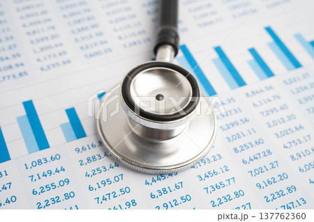 Stethoscope on chart or graph paper, Financial, account, statistics and business data medical health. Stethoscope on chart or graph paper, Financial, account, statistics and business data medical health. 137762360
