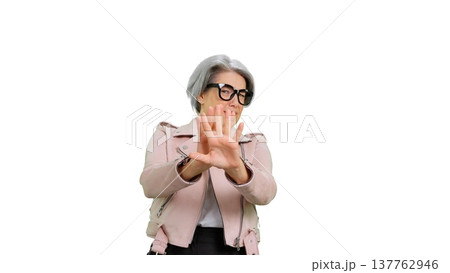 Mature woman showing stop gesture rejecting opinion Mature woman showing stop gesture rejecting opinion 137762946