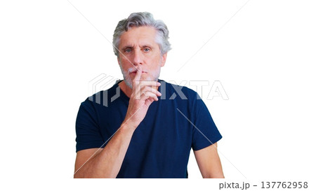 Mature man making silence gesture with finger on lips 137762958