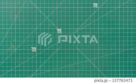 Green cutting mat with patterns or lines indicating the angle and size of the paper. For background and textured. 137763471