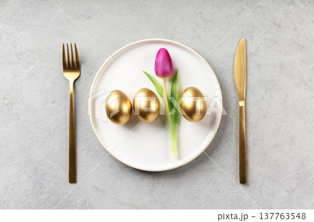 Elegant Easter Table Setting with Golden Eggs and Tulip Elegant Easter Table Setting with Golden Eggs and Tulip 137763548