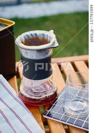 Pour over coffee dripper on glass carafe with empty serving glass Pour over coffee dripper on glass carafe with empty serving glass 137763894