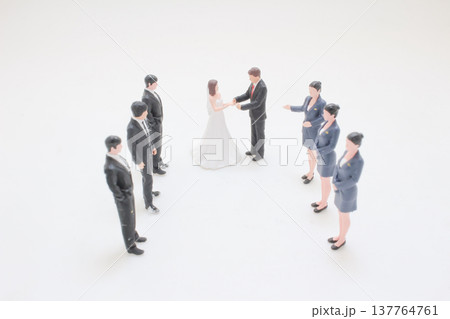 Miniature wedding couple stands joined together during formal ceremony Miniature wedding couple stands joined together during formal ceremony 137764761