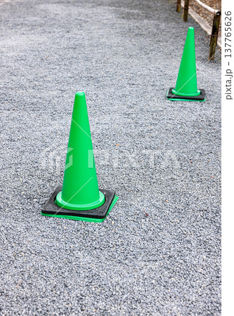 Green fluorescent, reflex traffic cones on road. 137765626